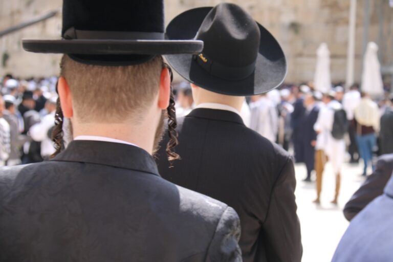 a man in a black suit and a man in a black hat